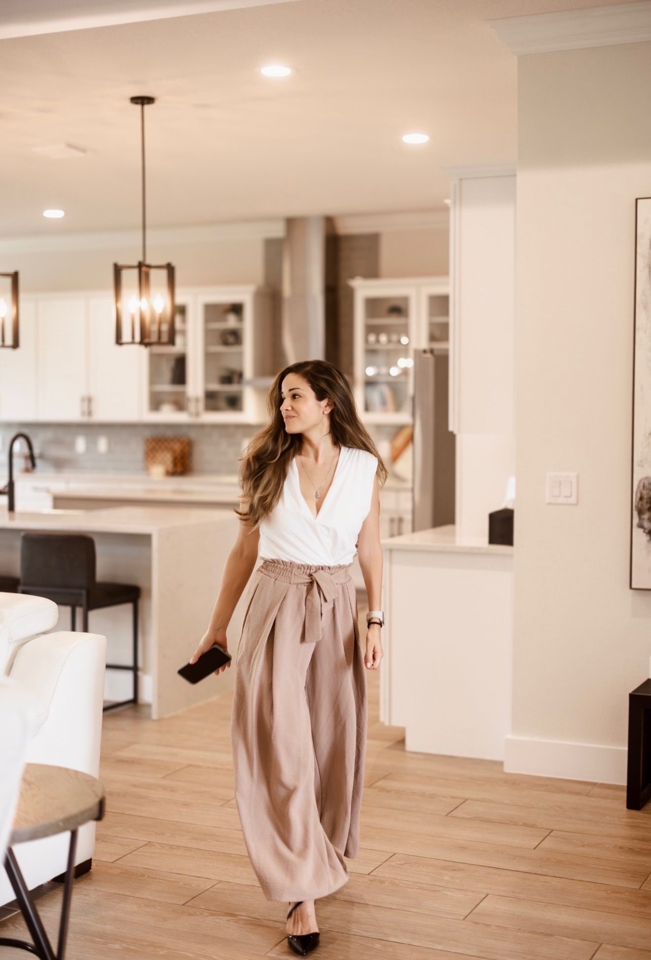 Business owner walking through a bright open workspace