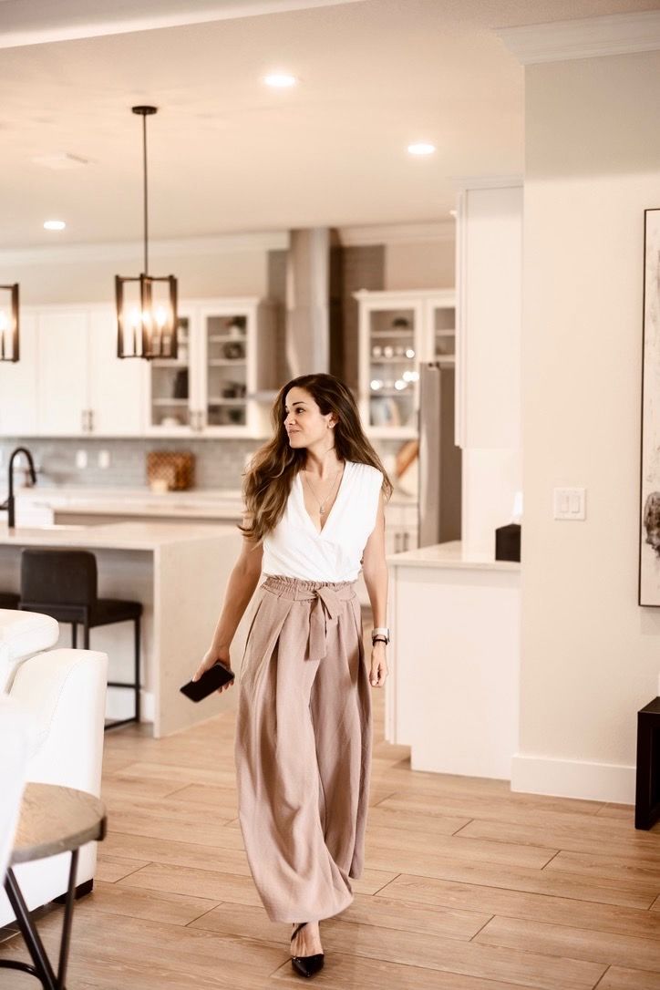 Business owner holding a phone in a modern kitchen space