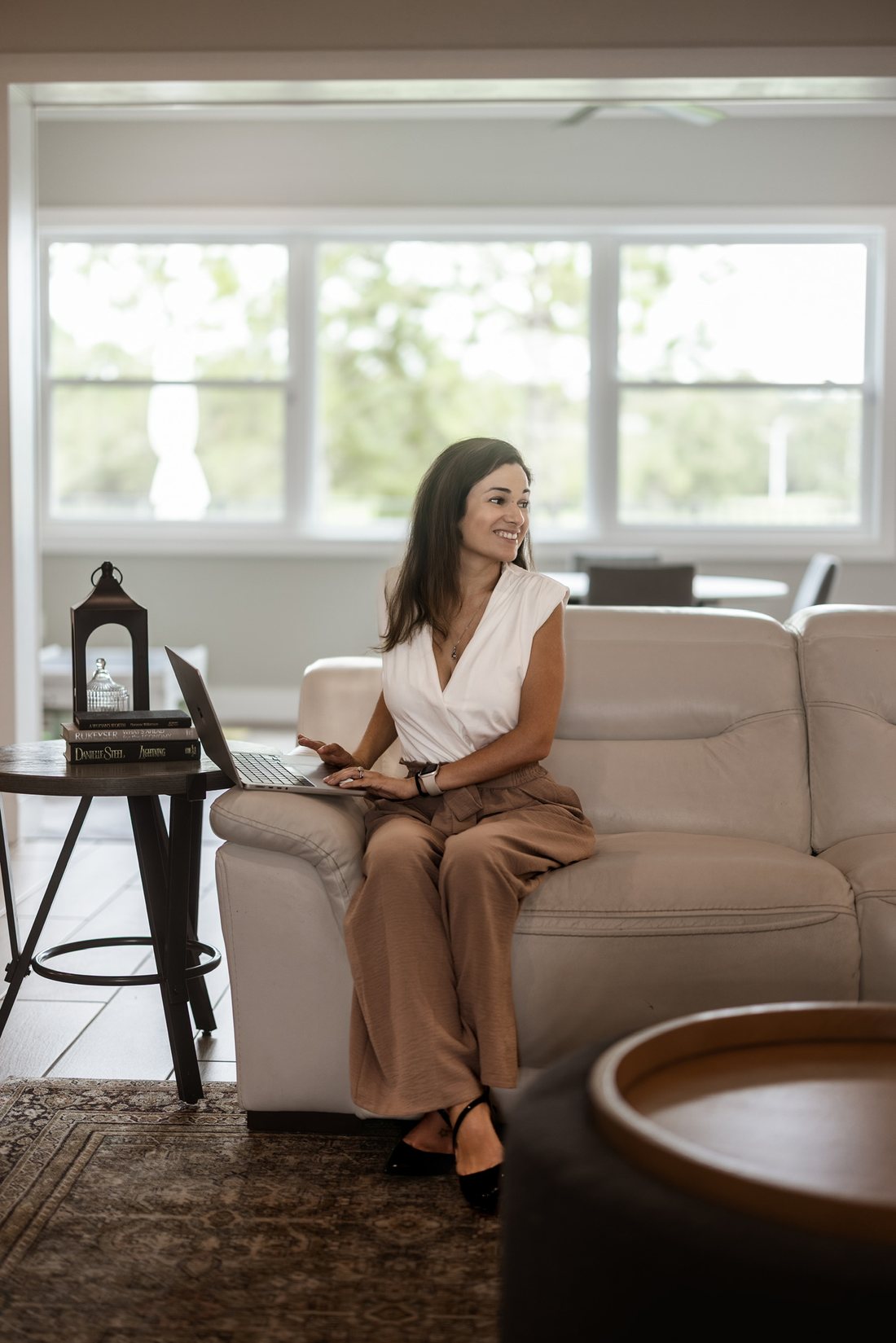 Business owner seated by a window in warm afternoon light