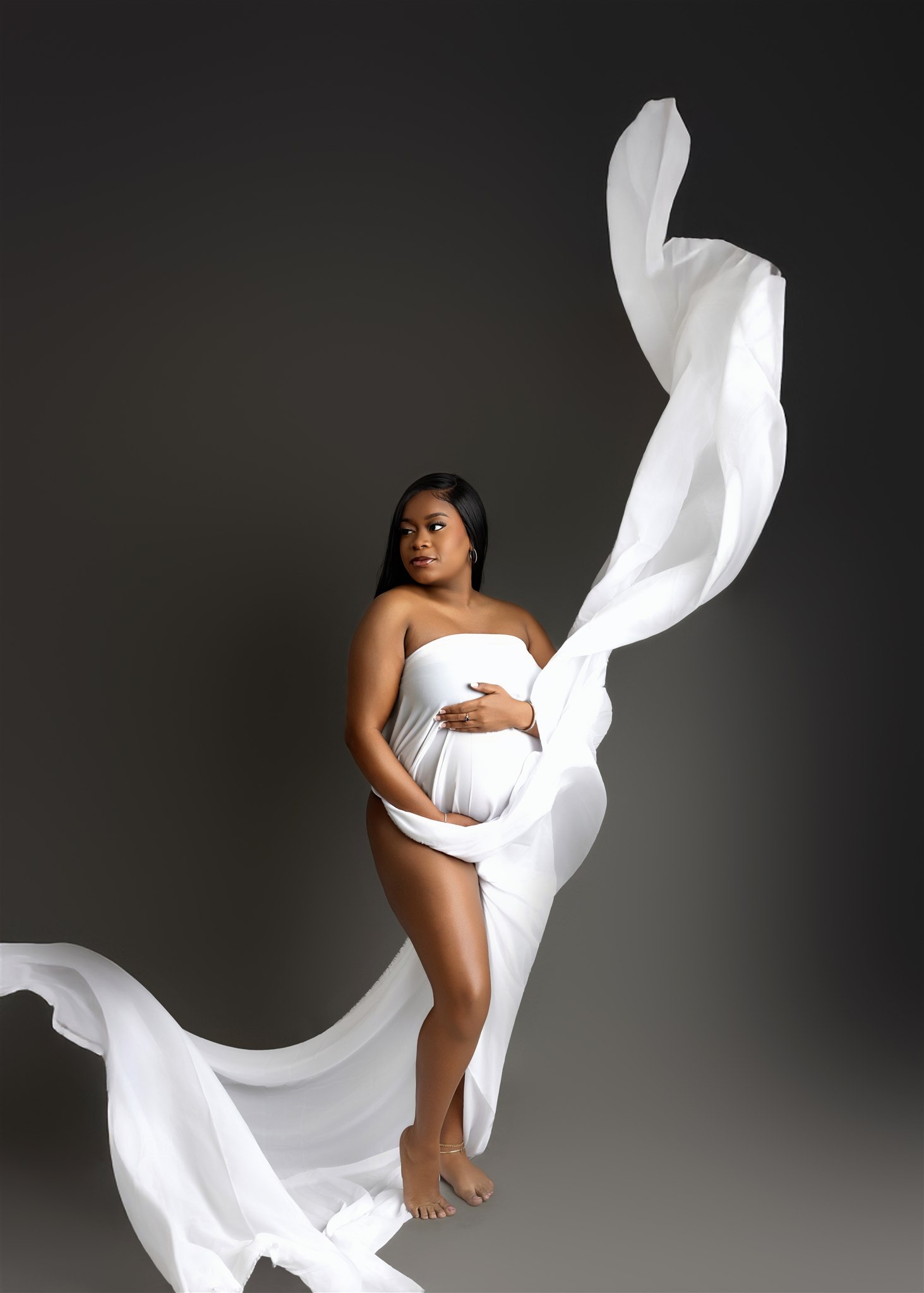 Dramatic maternity portrait - flowing fabric, dark backdrop